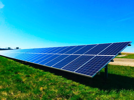 A solar panel array under a clear blue sky, symbolizing energy protection and sustainability, aligning with the article on protection charms.