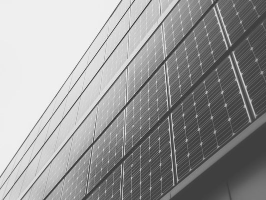 Rows of solar panels angled upwards, symbolizing sustainable energy protection in line with the theme of safeguarding personal energy.